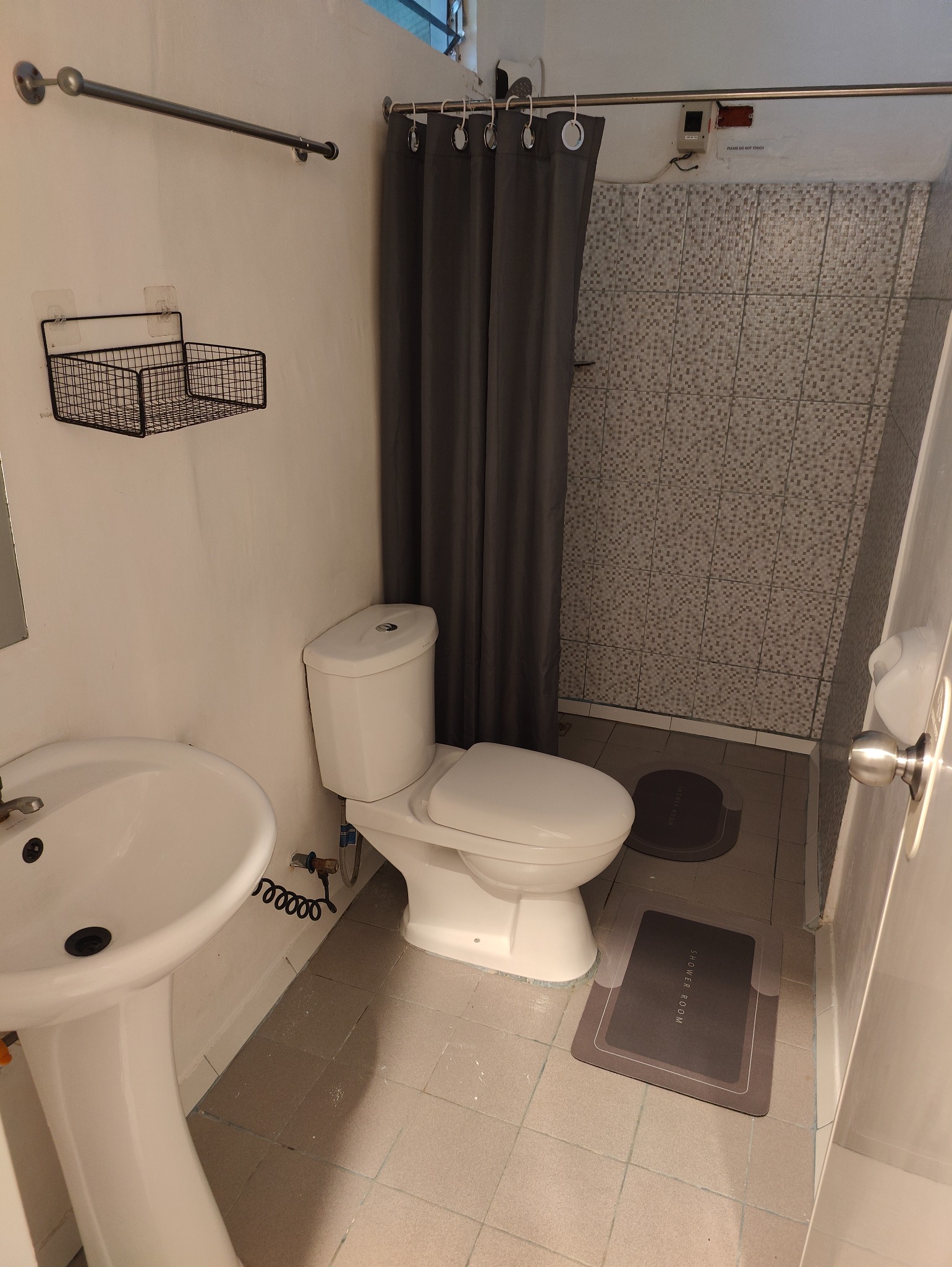 Bathroom with toilet, sink and shower area